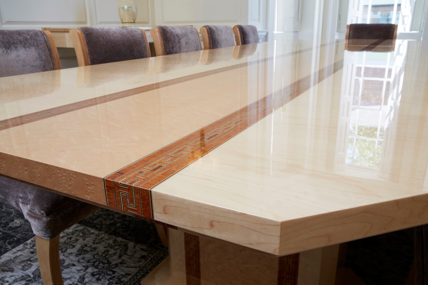 A close up photo of a bespoke wooden wine cabinet with wine and different size glasses