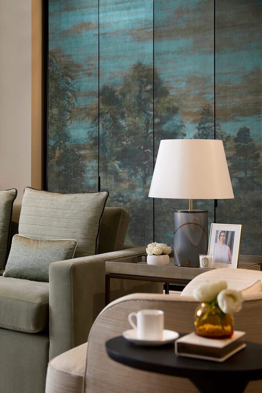 A close up shot in a living room with a lamp on a side table